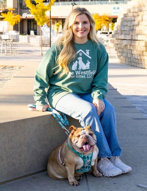 Pet sitter with dog in Westfield, enjoying outdoor city scenery.